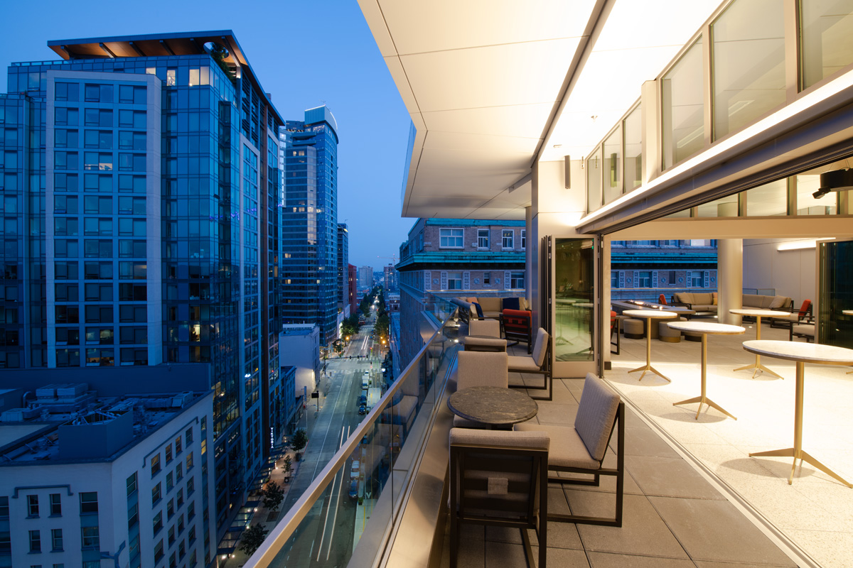 A balcony with a city view at dusk